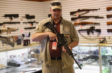 Shop owner Jeff Binkley displays an AR-15 'Sport' rifle at Sarge's Sidearms on September 29, 2016 near Benson, Arizona. He said he redesigned and renamed his store just this year. Gun shops are proliferate in Arizona, which regulates and restricts weapons less than anywhere in the United States.