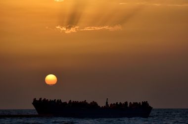 Migrants wait to be rescued as they drift at sunset in the Mediterranean Sea some 20 nautical miles north off the coast of Libya.