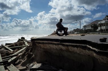 Bug Mohani steers his wheelchair along a part of a highway washed out by Hurricane Matthew in Flagler Beach, Florida, on October 9th, 2016.