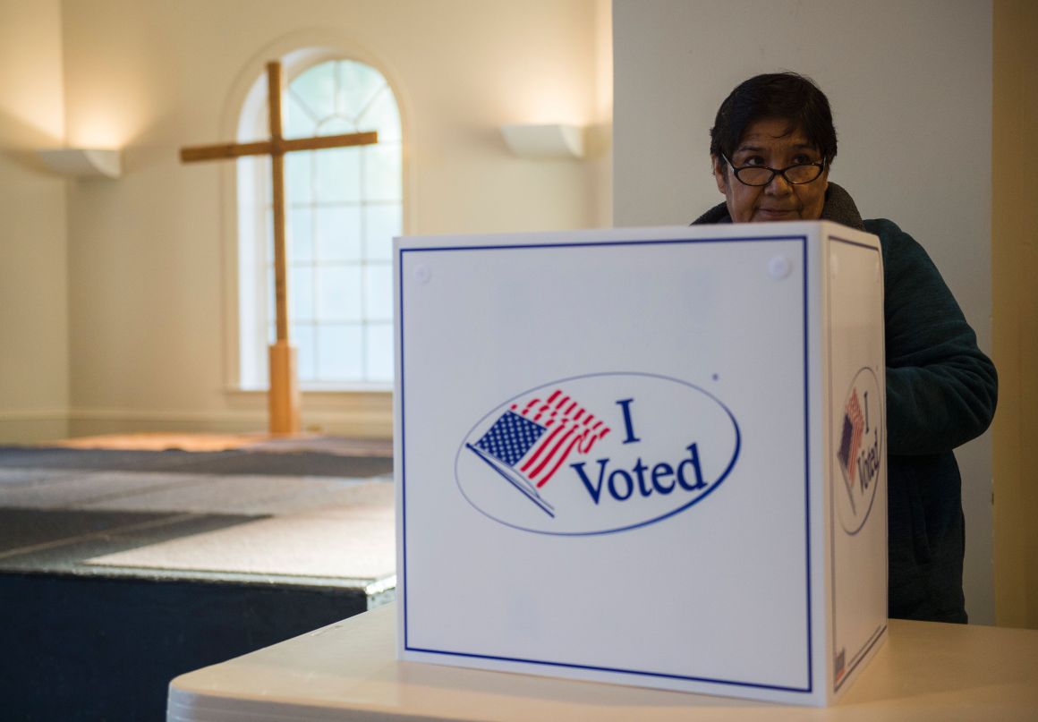 A woman casts her ballot at a church polling station in Fairfax, Virginia, during the U.S. presidential election on November 8th, 2016.