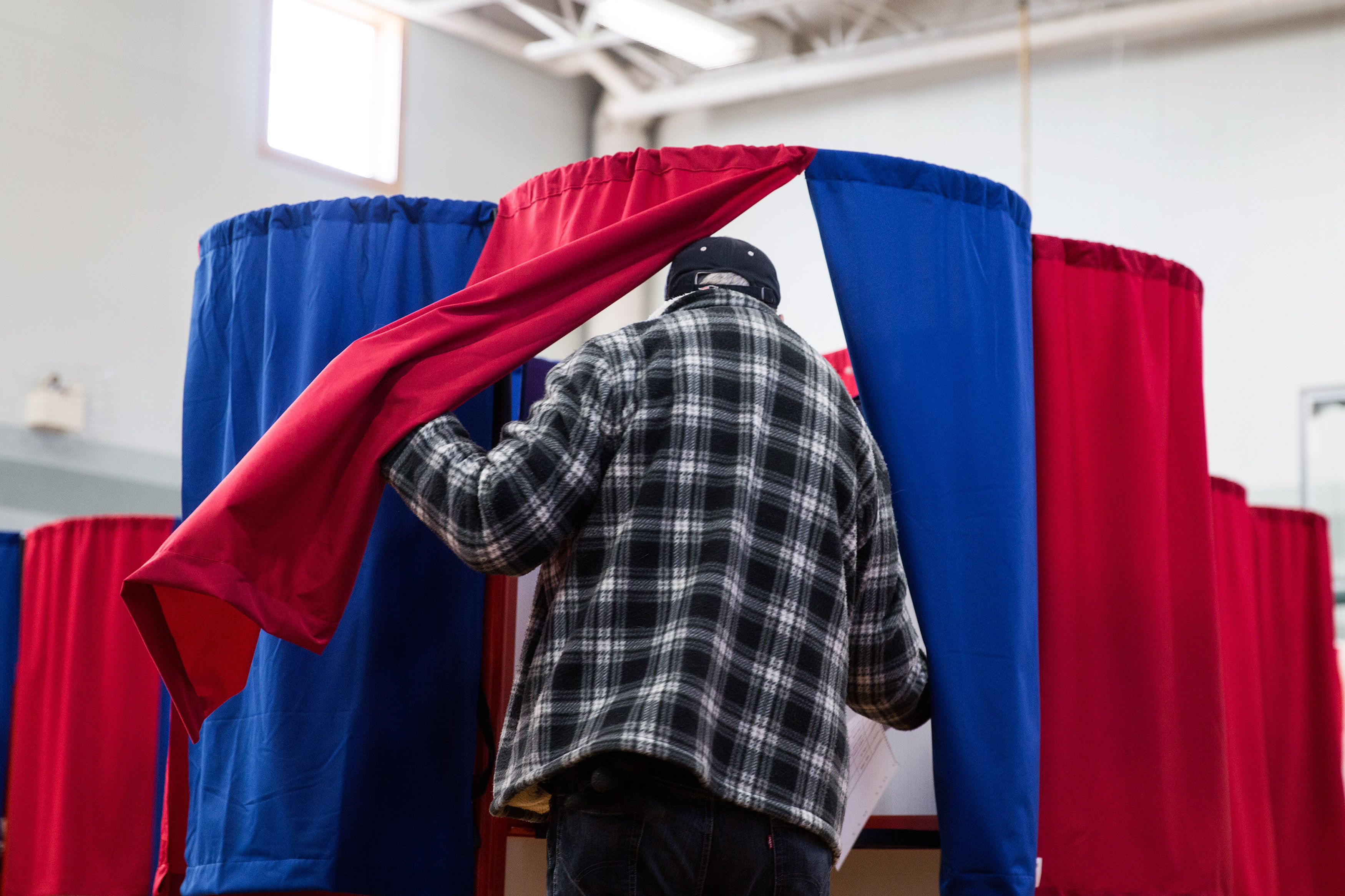 A man casts his vote at Amherst Street Elementary School on November 8th, 2016, in Nashua, New Hampshire.