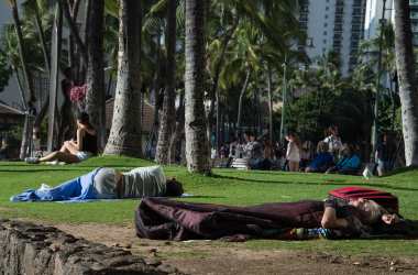 Homeless people sleep in a park off in Honolulu, Hawaii, on December 17th, 2016.