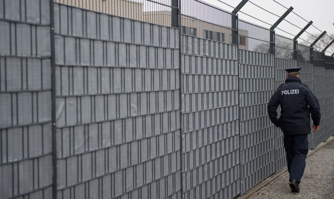 A policeman walks past the Higher Regional Court in Dresden, Germany.