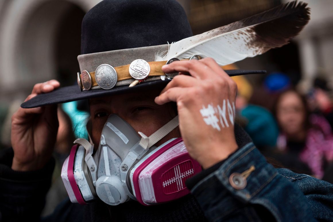 An activist adjusts his hat while protesting the Keystone XL Pipeline during the Native Nations Rise protest on March 10th, 2017, in Washington, D.C.