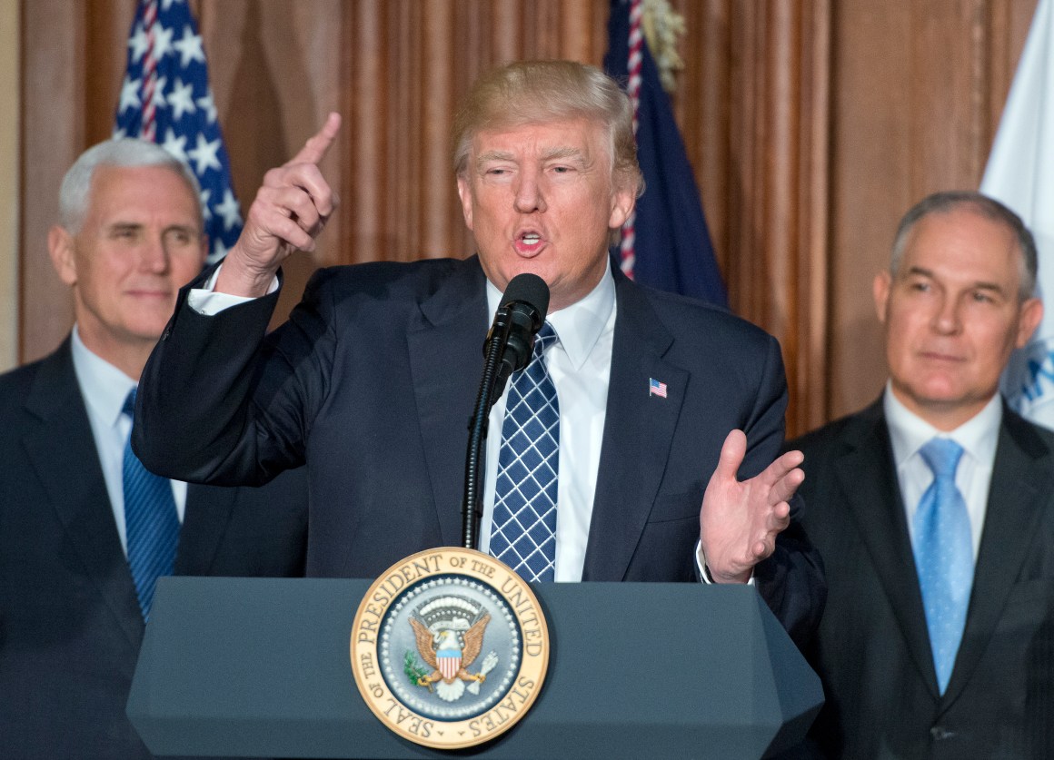 President Donald Trump speaks on March 28th, 2017, in Washington, DC. The order reverses the Obama-era climate change policies. US Vice President Mike Pence look on from left and EPA Administrator Scott Pruitt looks on from the right.