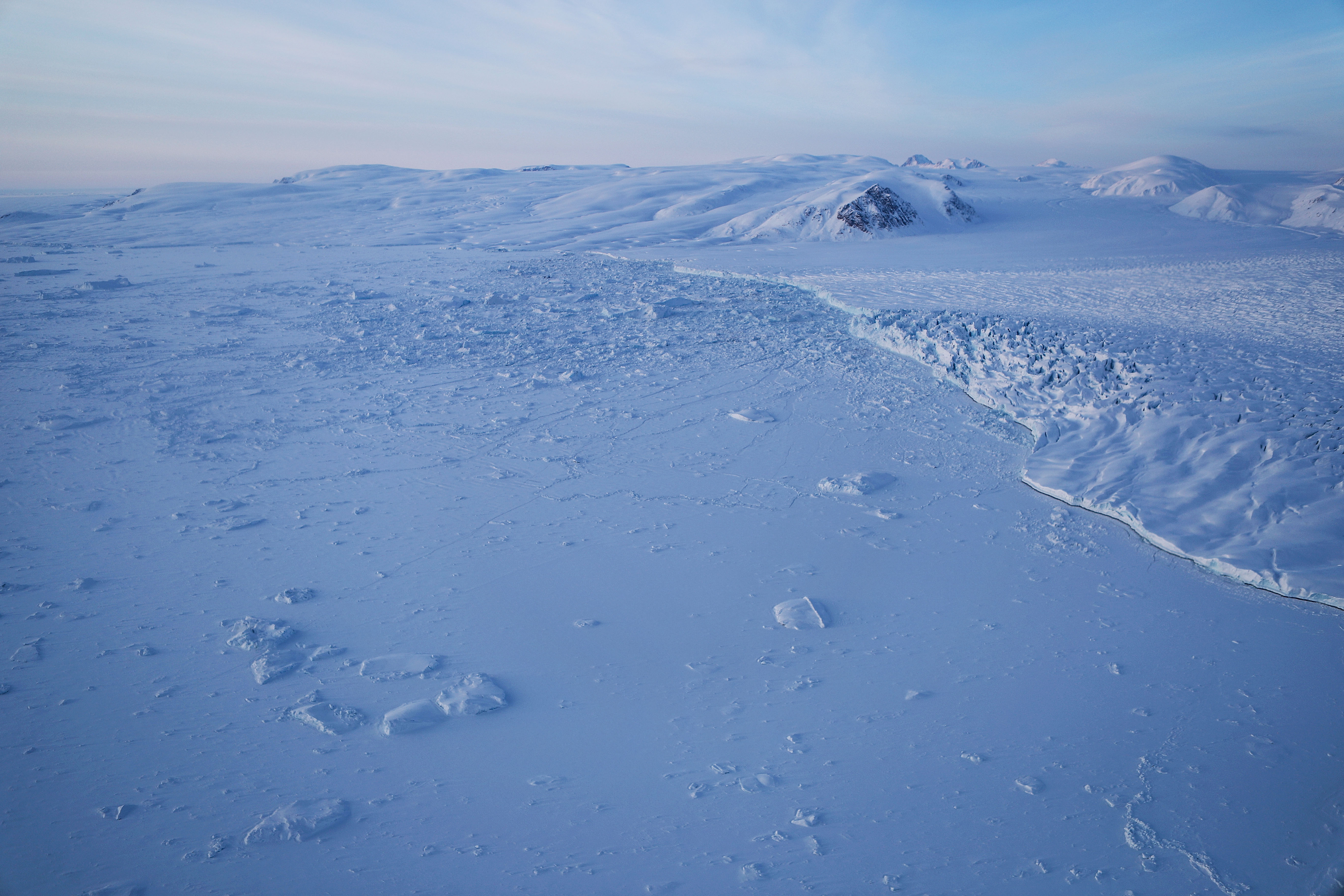 A glacier and sea ice are seen from NASA's Operation IceBridge research aircraft on March 30th, 2017, above Ellesmere Island, Canada.