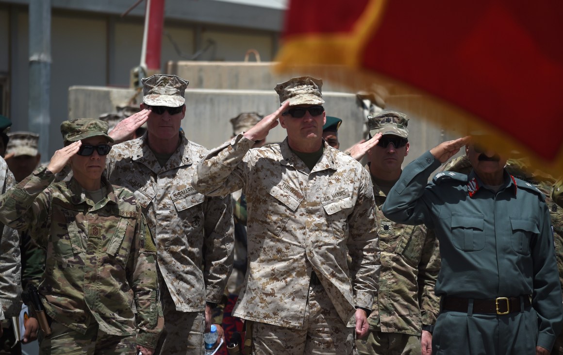 U.S. Marine Brigadier General Roger Turner and Afghan officials salute during a handover ceremony at Leatherneck Camp in Lashkar Gah in Helmand Province on April 29th, 2017.