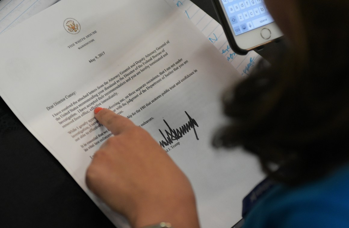 A journalist looks at a copy of the termination letter to Federal Bureau of Investigation Director James Comey from President Donald Trump.