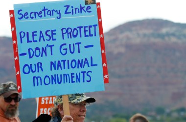 A man holds a sign on May 10th, 2017, protesting the shrinking of Bears Ears and Grand Staircase-Escalante National Monuments.