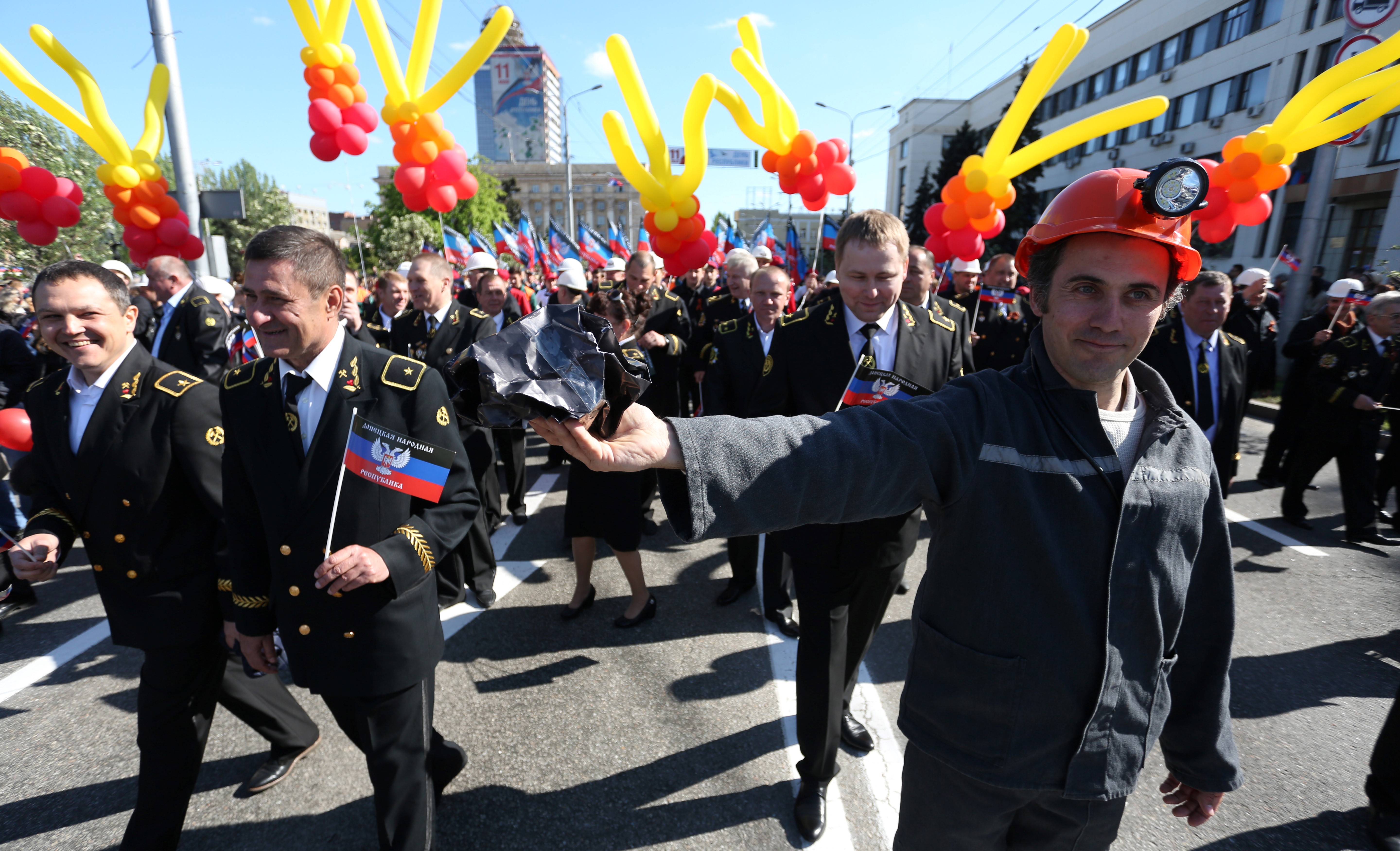 People carry flags and balloons during a rally in Donetsk on May 11th, 2017, to mark the third anniversary of a referendum on the declaration of the Donetsk People's Republic.