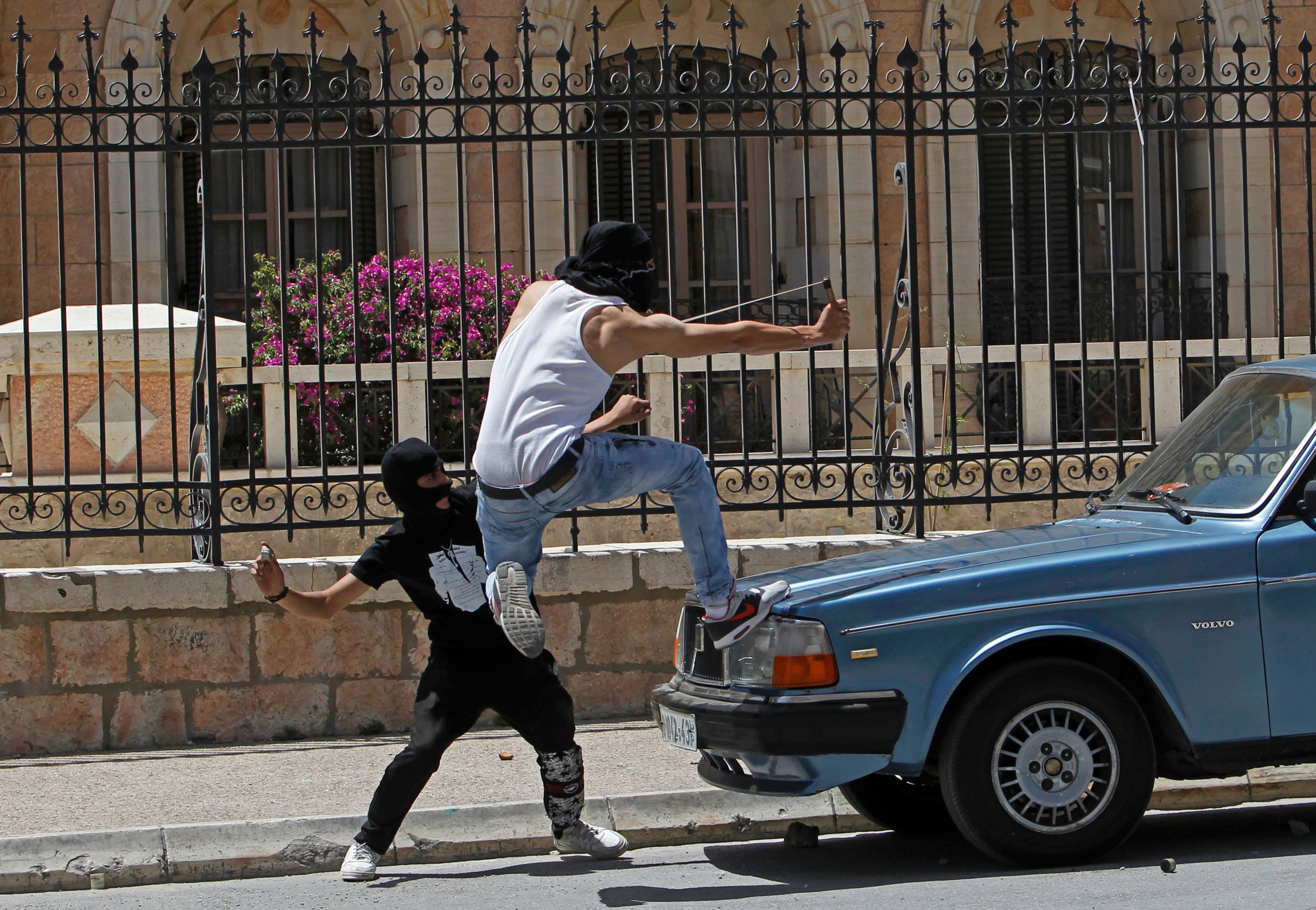 A Palestinian protester throws stones toward Israeli security forces during clashes in the West Bank town of Bethlehem on May 15th, 2017.