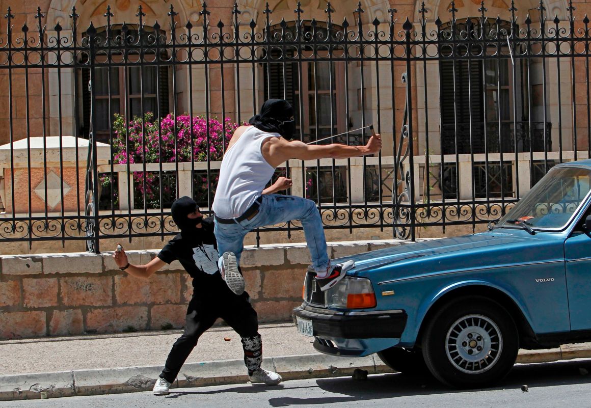 A Palestinian protester throws stones toward Israeli security forces during clashes in the West Bank town of Bethlehem on May 15th, 2017.