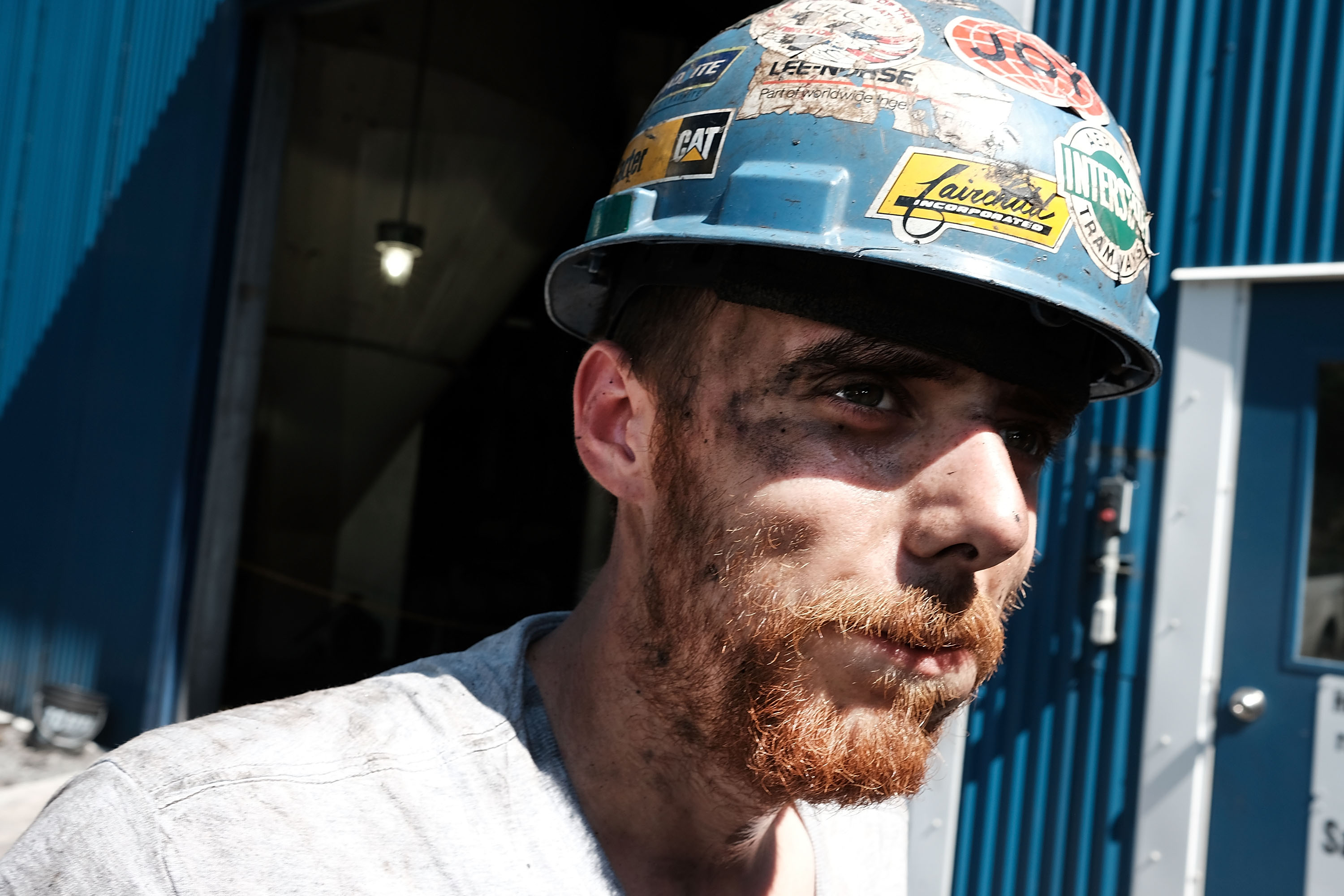 Coal worker Adam Burton pauses while working at a coal prep plant on May 19th, 2017, outside the city of Welch, West Virginia.