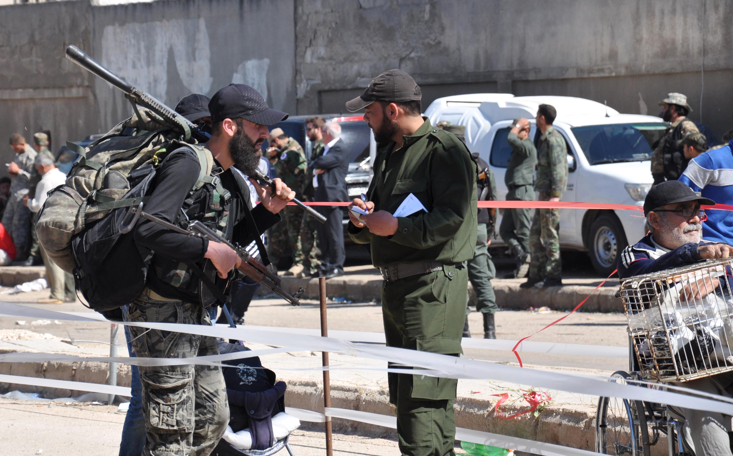 Syrian opposition fighters are stopped at a checkpoint manned by regime forces ahead of their evacuation from the al-Waer neighborhood, the last opposition-held district in the city of Homs, on May 21st, 2017.