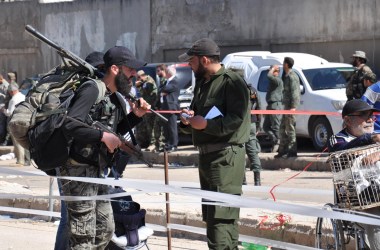 Syrian opposition fighters are stopped at a checkpoint manned by regime forces ahead of their evacuation from the al-Waer neighborhood, the last opposition-held district in the city of Homs, on May 21st, 2017.