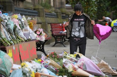 A 13-year-old girl who attended the Ariana Grande concert looks at floral tributes and messages in Manchester, England, on May 24th, 2017.