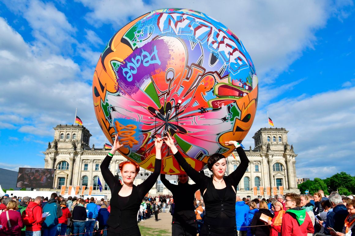 Performers carry a giant graffiti ball during the opening Mass of the Kirchentag (Church Day) festival in Berlin, Germany, celebrating the 500th anniversary of the Reformation, on May 24th, 2017.