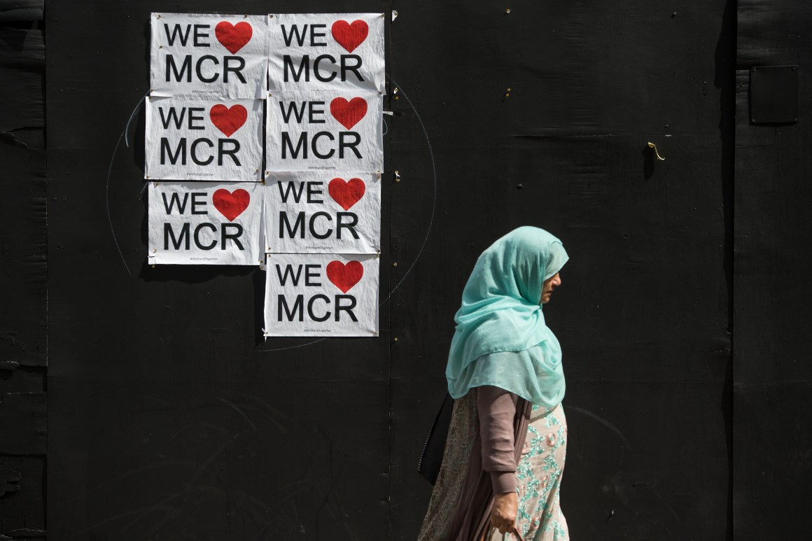 A woman walks past a poster displaying a message of defiance after the terror attack of May 22nd in Manchester, England, on May 31st, 2017.