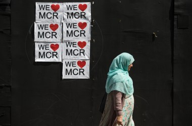 A woman walks past a poster displaying a message of defiance after the terror attack of May 22nd in Manchester, England, on May 31st, 2017.