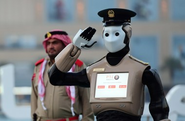 The world's first operational police robot stands at attention in Dubai before a military cannon is fired to mark the end of the fasting day on May 31st, 2017, for Muslims observing Ramadan.