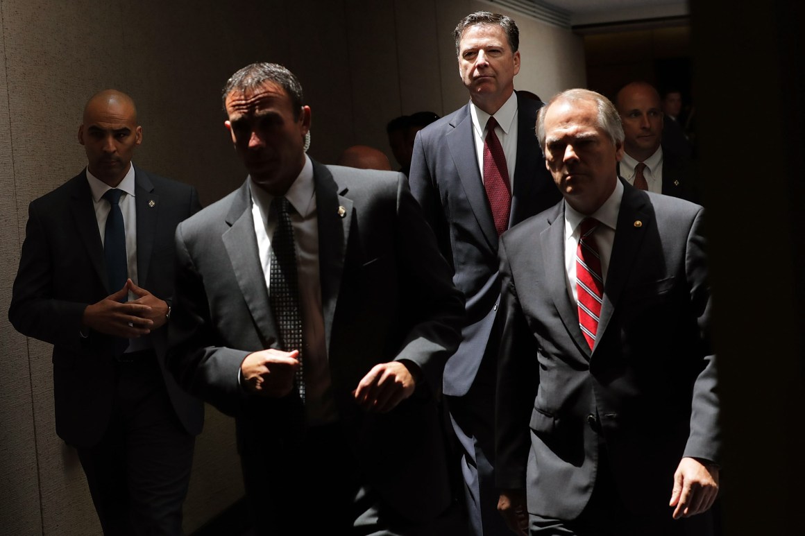 James Comey (second from the right) moves from an open hearing to a closed hearing during a break in testimony before the Senate Intelligence Committee on June 8th, 2017.