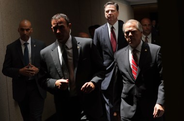 James Comey (second from the right) moves from an open hearing to a closed hearing during a break in testimony before the Senate Intelligence Committee on June 8th, 2017.