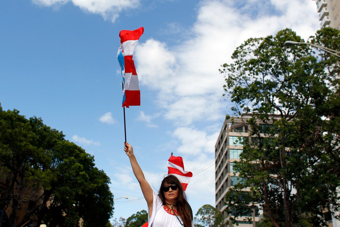 A woman waves a Puerto Rican flag during a protest against the referendum for Puerto Rico political status in San Juan, on June 11th, 2017.