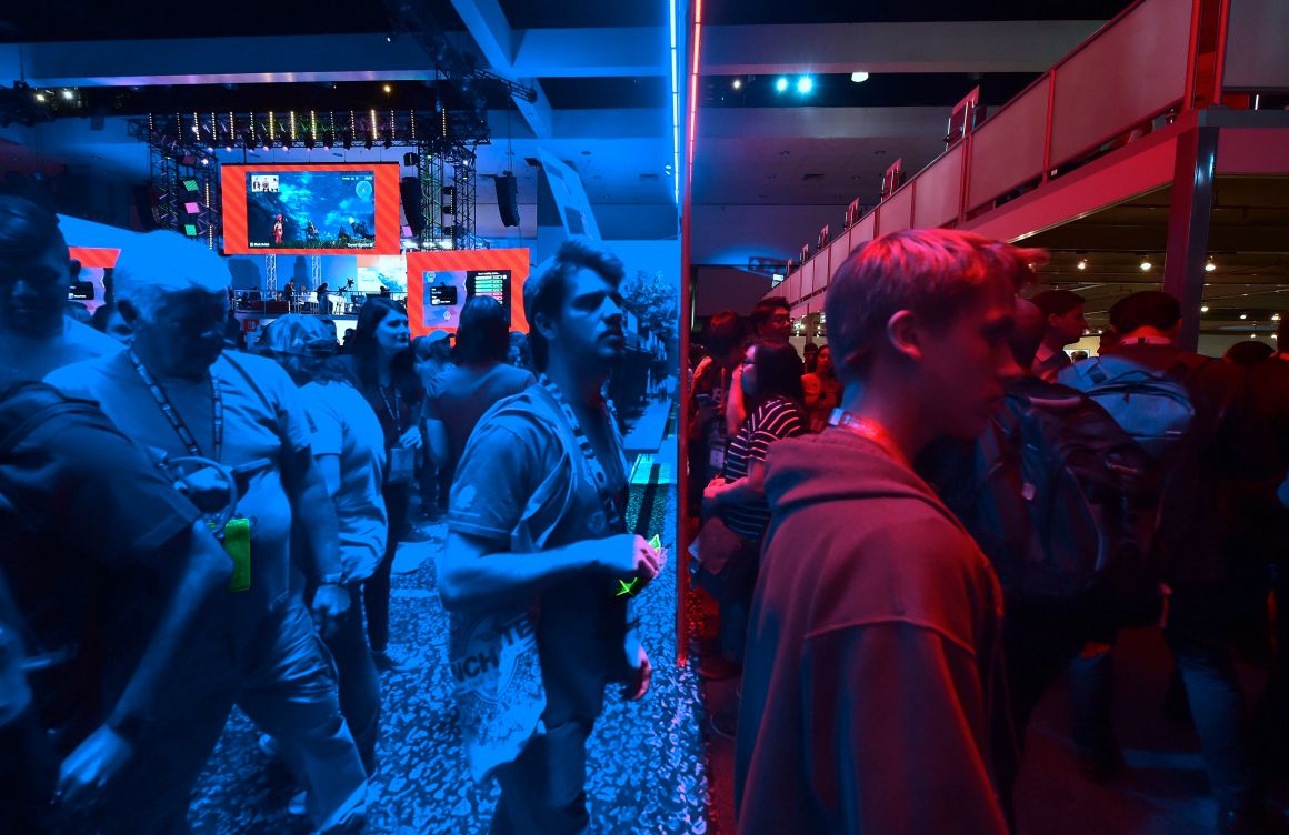 Gaming fans step from the Playstation blue into the Nintendo red display rooms on day one of E3 2017, the three-day Electronic Entertainment Expo, one of the biggest events in the gaming industry calendar, on June 13th, 2017 in Los Angeles, California.