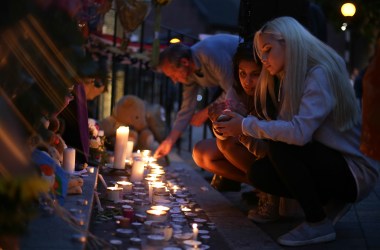 People light candles as they observe a vigil outside Notting Hill Methodist Church following the blaze at Grenfell Tower, a residential tower block in west London on June 15th, 2017.