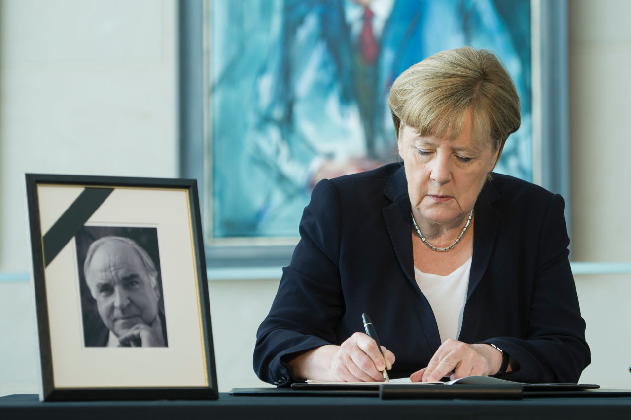 German Chancellor Angela Merkel writes in a condolences book for former chancellor Helmut Kohl on June 18th, 2017, in Berlin, Germany.