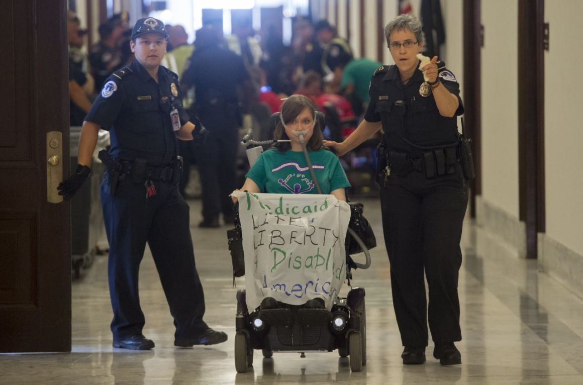 Police arrest a woman protesting against the Senate Republicans' draft health-care bill outside the Capitol Hill office of Senate Majority Leader Mitch McConnell on June 22nd, 2017.