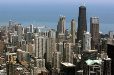 The John Hancock building dominates the Chicago skyline with Lake Michigan in the background.