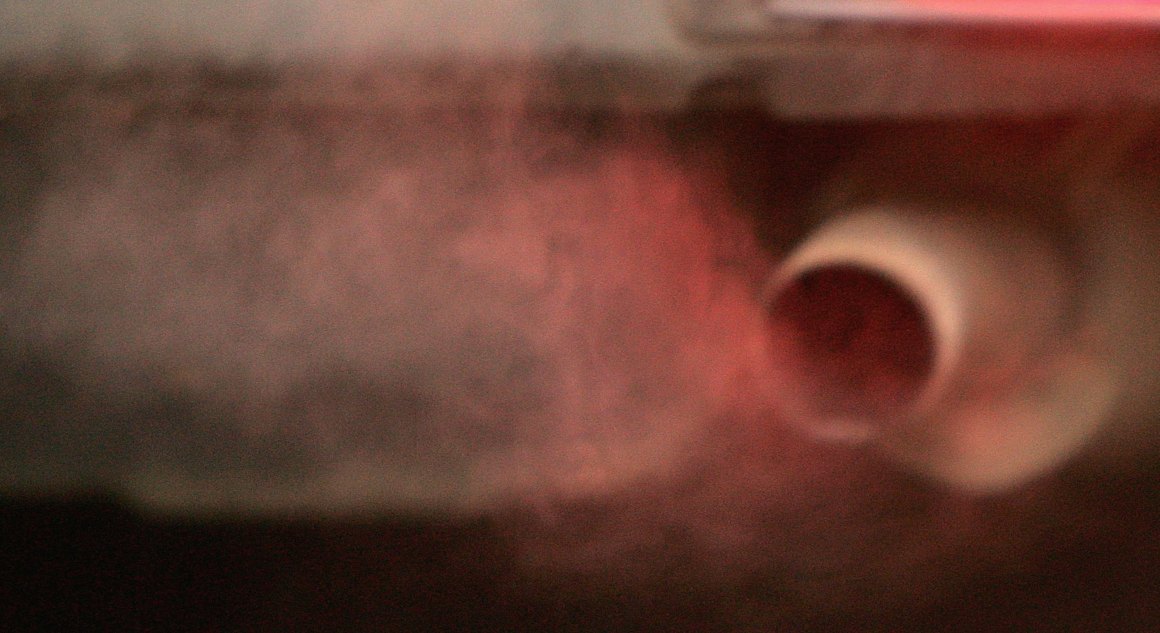 An exhaust pipe releases fumes.