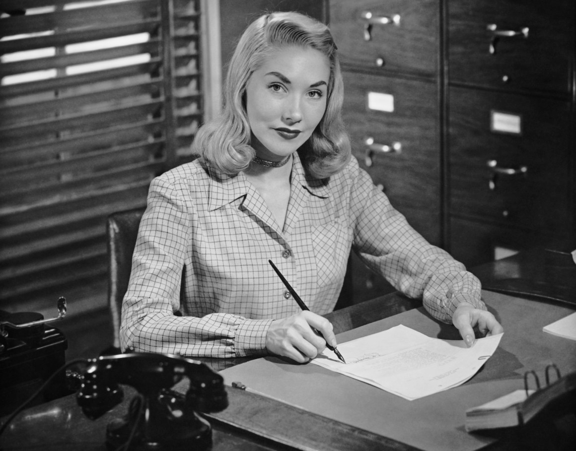 An office worker writing letter in the 1950s.