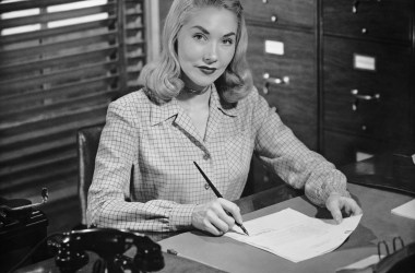 An office worker writing letter in the 1950s.