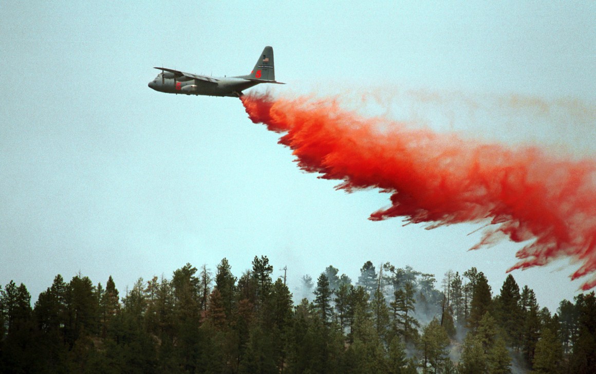 A slurry bomber drops its load on a ridge in an effort to stop the Hayman Fire on June 14th, 2002, in Deckers, Colorado.