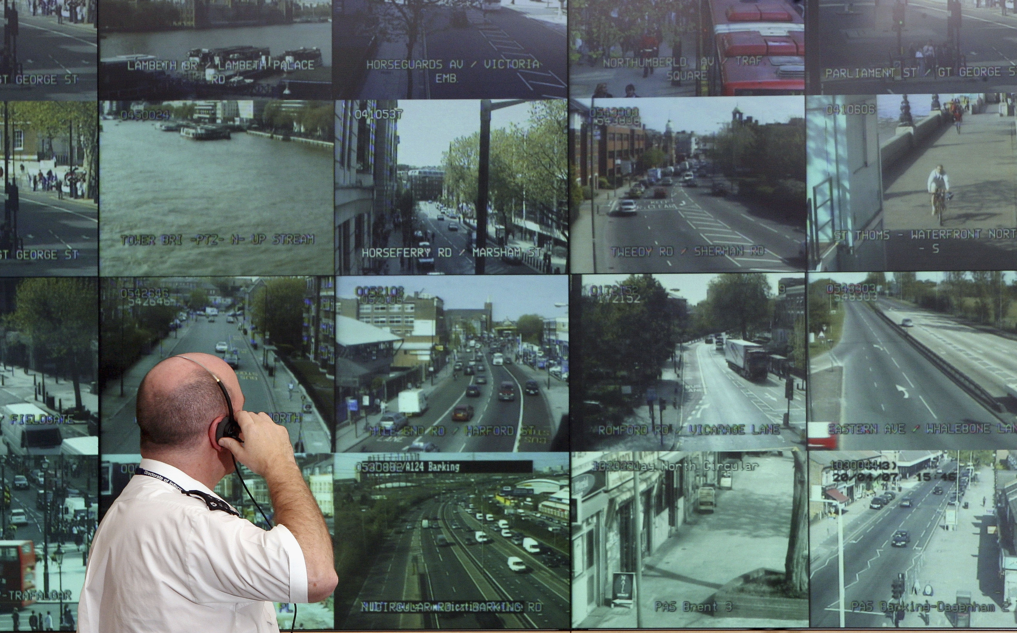 A police officer watches television monitors showing a fraction of London's CCTV camera network in the Metropolitan Police's new Special Operations Room in London, England.