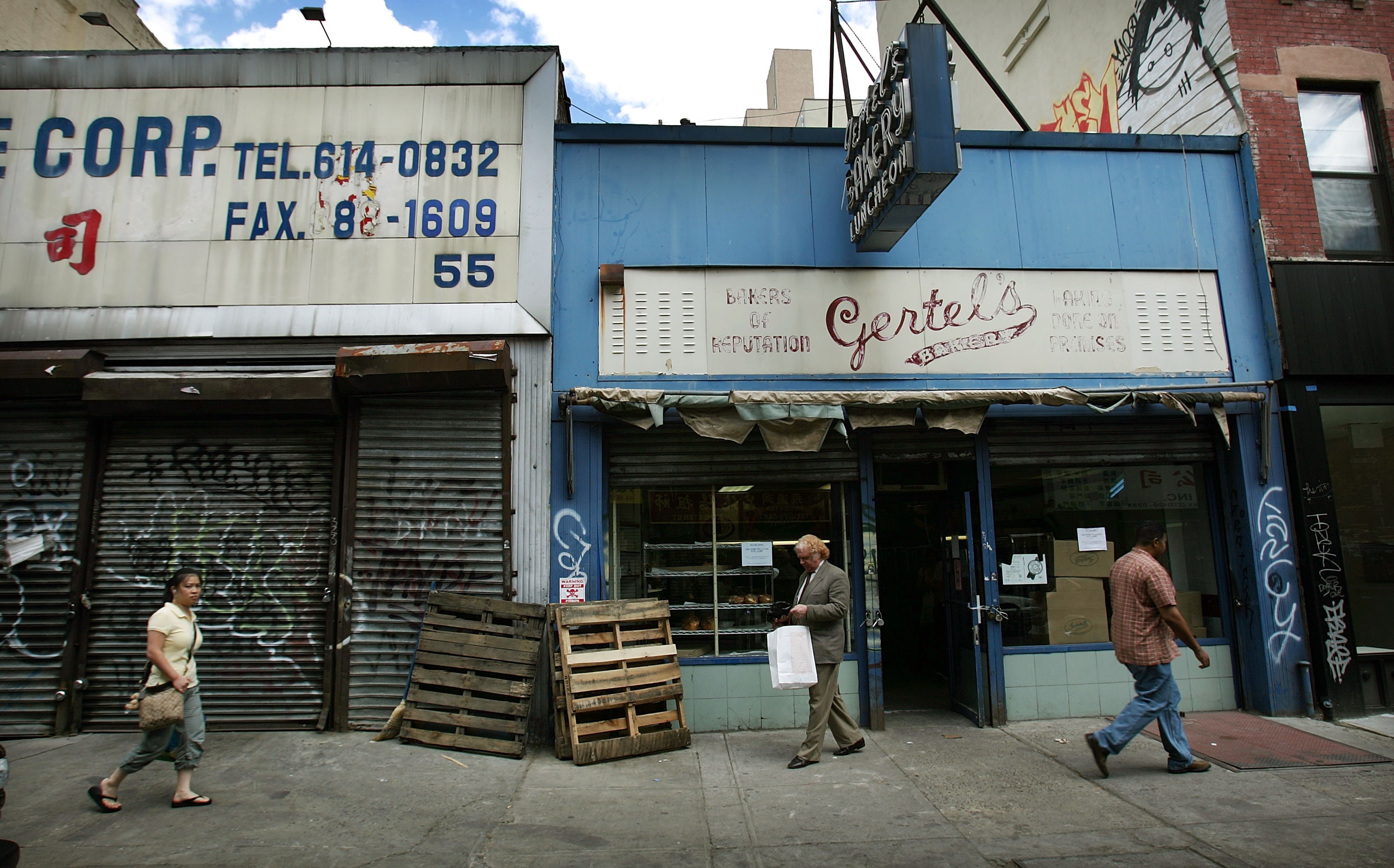 A customer walks out the front door on the last day of business for Gertel's Bake Shop, a kosher eatery, on June 22nd, 2007, in New York City.