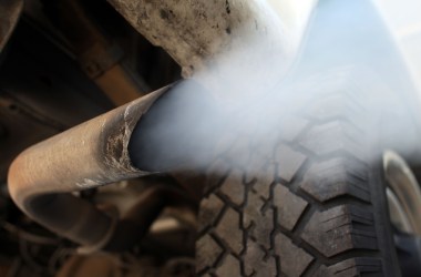 Exhaust flows out of the tailpipe of a vehicle at , 'Mufflers 4 Less', July 11th, 2007, in Miami, Florida.