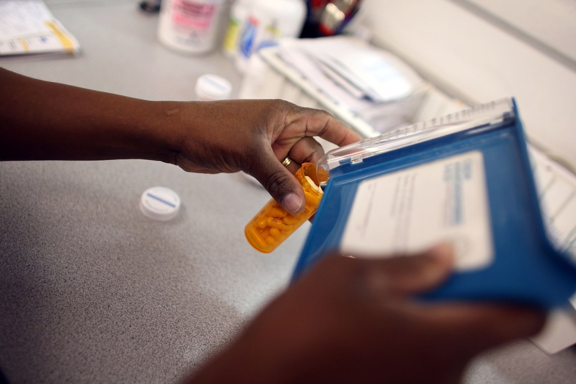 Rosemary Petty, a Publix Supermarket pharmacy technician, counts out a prescription of antibiotic pills on August 7th, 2007, in Miami, Florida.