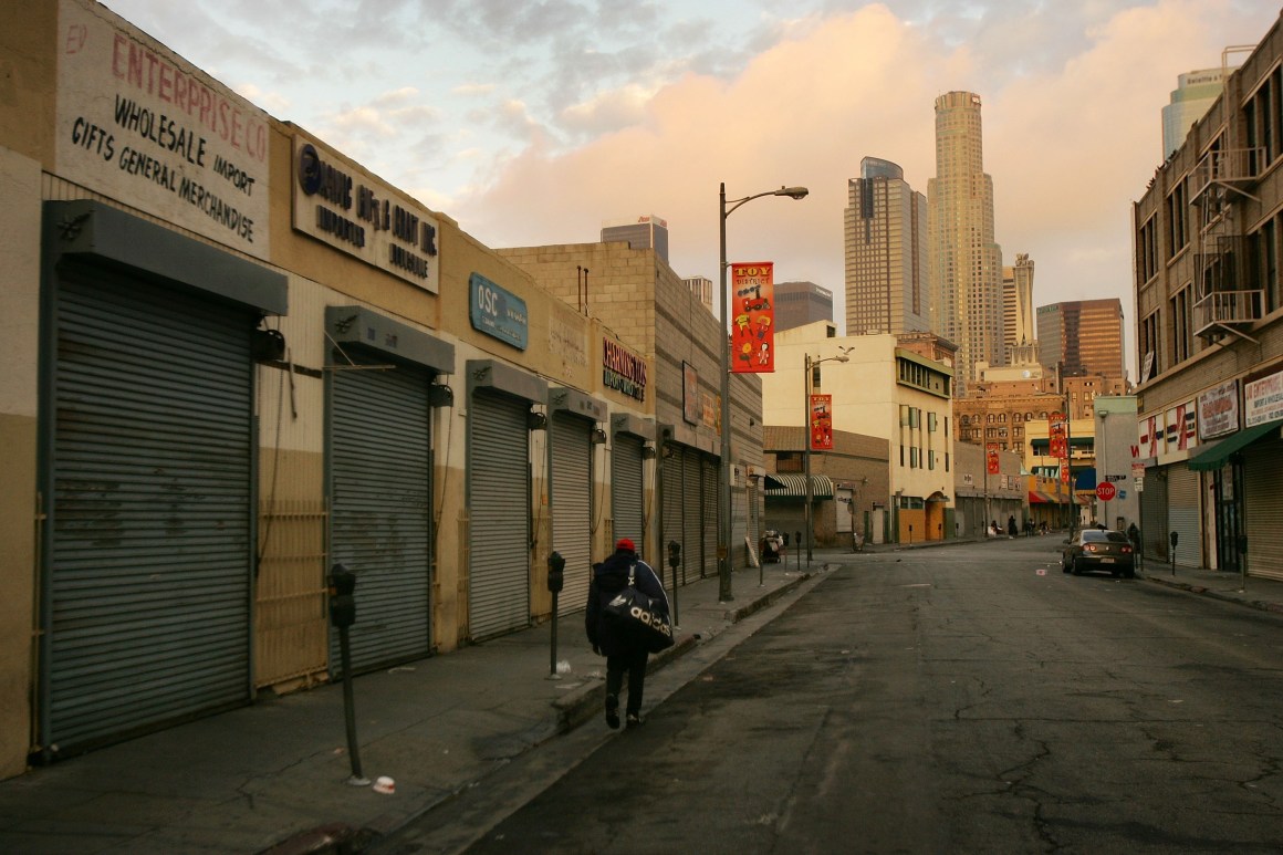 A homeless man walks down the street in the downtown Skid Row area of Los Angeles, California.