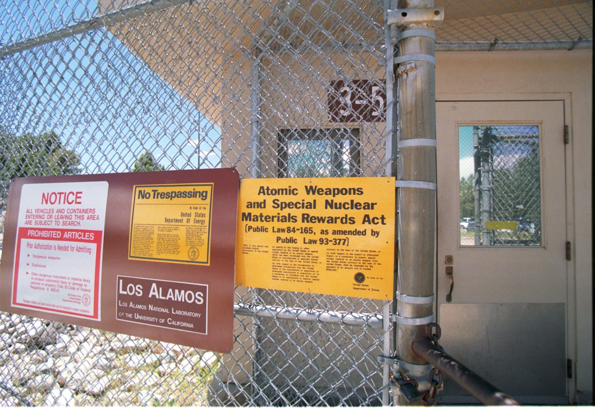 Signs are posted on the gated wall around the main technical area of Los Alamos National Laboratory, New Mexico.