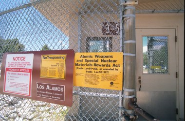 Signs are posted on the gated wall around the main technical area of Los Alamos National Laboratory, New Mexico.