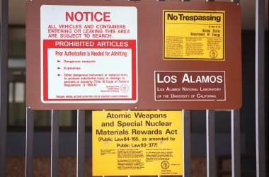 Signs are posted on the gated wall around the main technical area of Los Alamos National Laboratory in New Mexico.