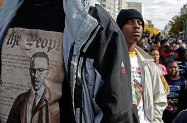 Lloyd Marshall (L) wears a Malcolm X shirt while participating in a march around the Department of Justice to protest hate crimes on November 16th, 2007, in Washington, D.C.