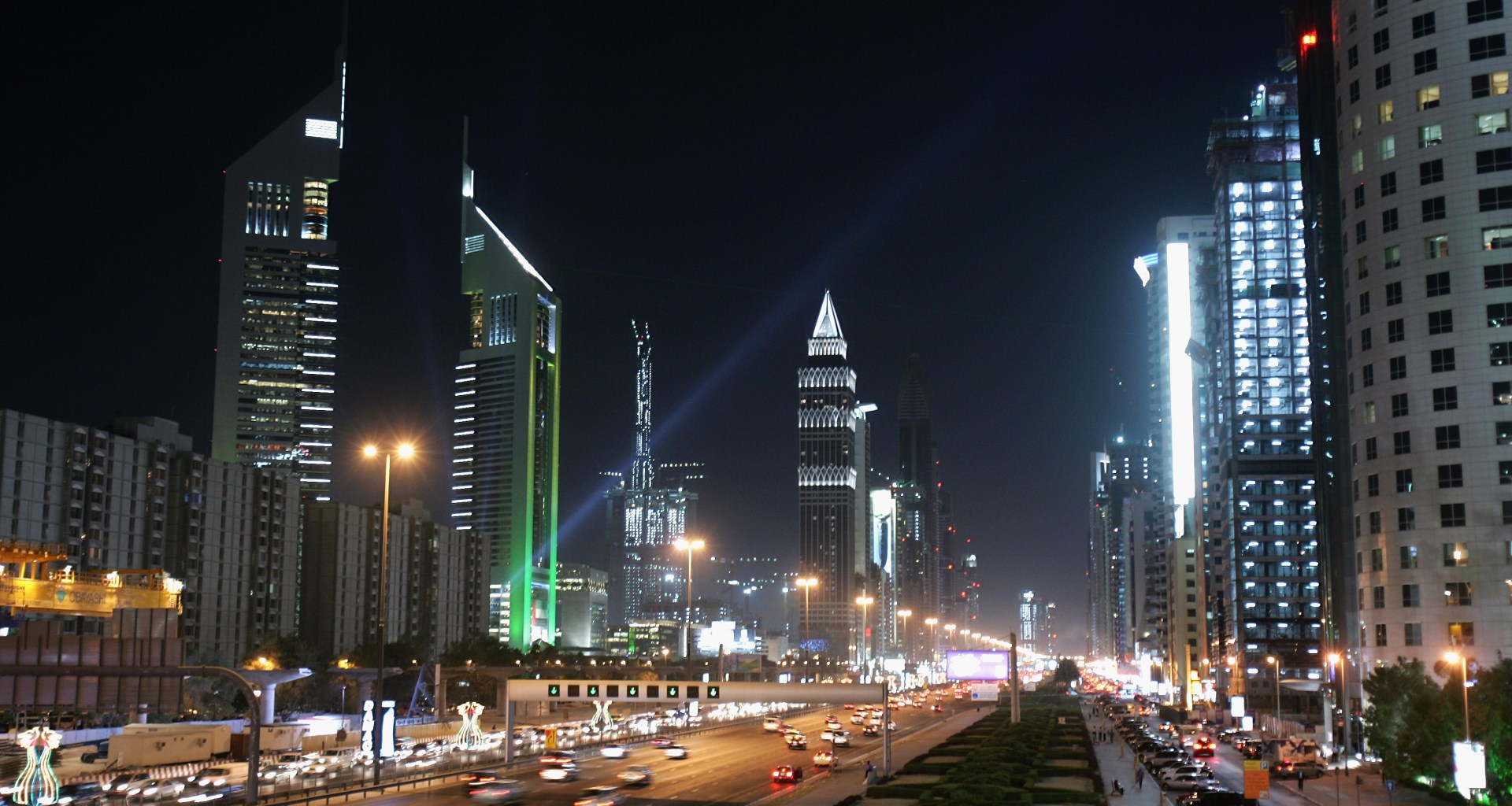 The iconic Emirates Towers dominate the skyline beside the wide boulevard of Sheikh Zayed Road on December 3rd, 2007, in Dubai, United Arab Emirates.