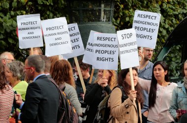 Demonstrators hold banners during a meeting of Norwegian Prime Minister Erna Solberg with Brazilian President Michel Temer in Oslo on June 23rd, 2017.