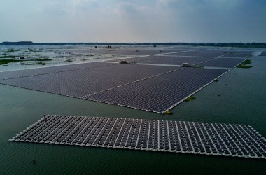 A boat tows a group of solar panels before they are connected to a large floating solar farm project on June 14th, 2017, in Huainan, Anhui province, China.