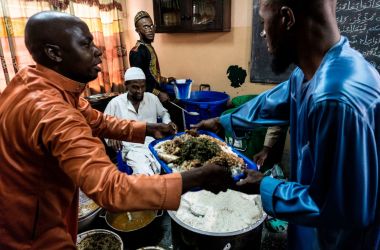 People distribute food to fellow Muslim worshippers before breaking the Ramadan fast on June 25th, 2017, in Kinshasa, Democratic Republic of the Congo.