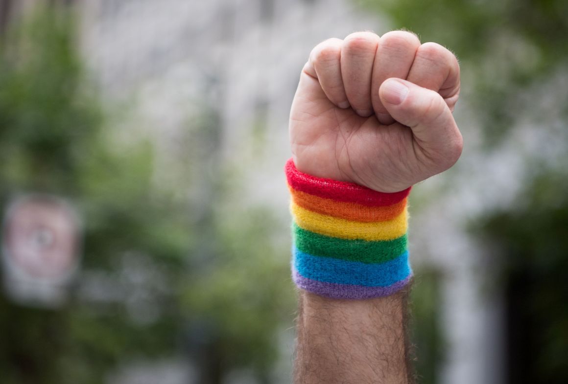 A man raises a fist while marching along the parade route during the San Francisco Pride parade in San Francisco, California, on Sunday, June 25th, 2017.